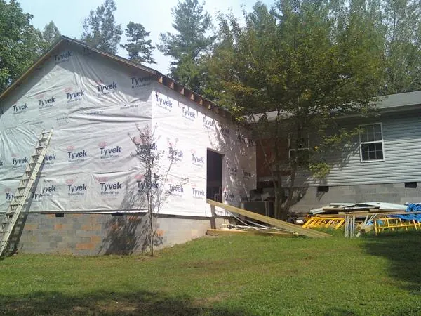 Tyvek wrapped gable on a new room addition beside an existing home in Hennepin