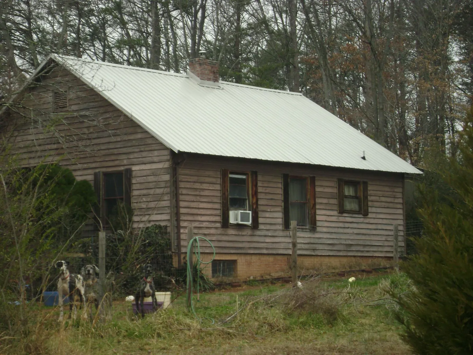 White metal roof on an old wood sided farmhouse, from a Metal Roof Installation job in Hennepin